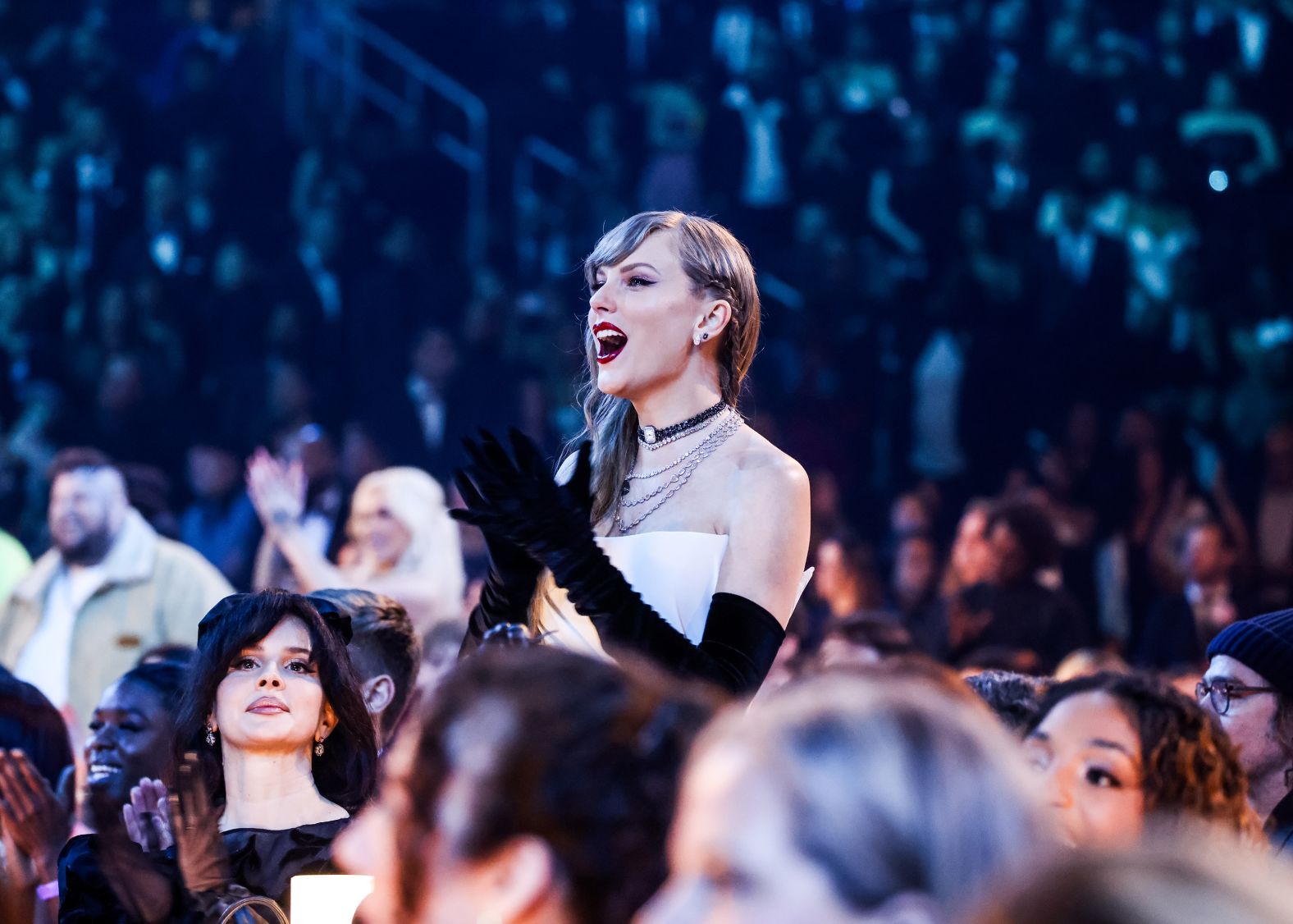 Swift enjoys the show from the audience. She was often seen dancing to the various performances.