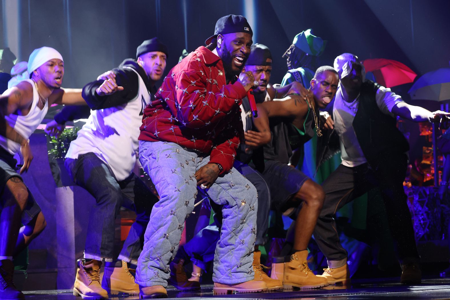 Burna Boy performs with backup dancers during the show.