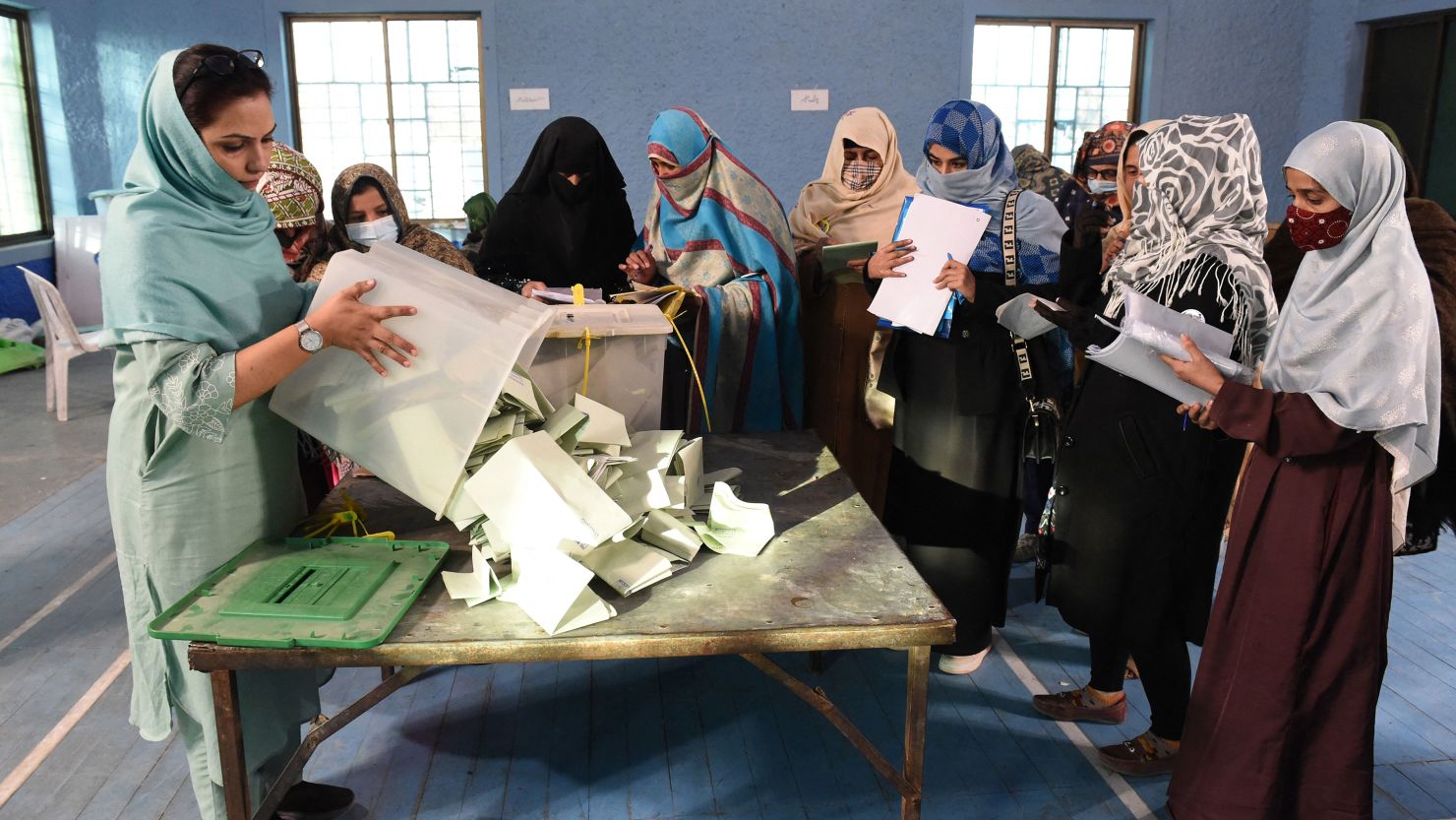 Polling staff opening ballot boxes in Quetta at the end of Pakistan national elections on February 8, 2024