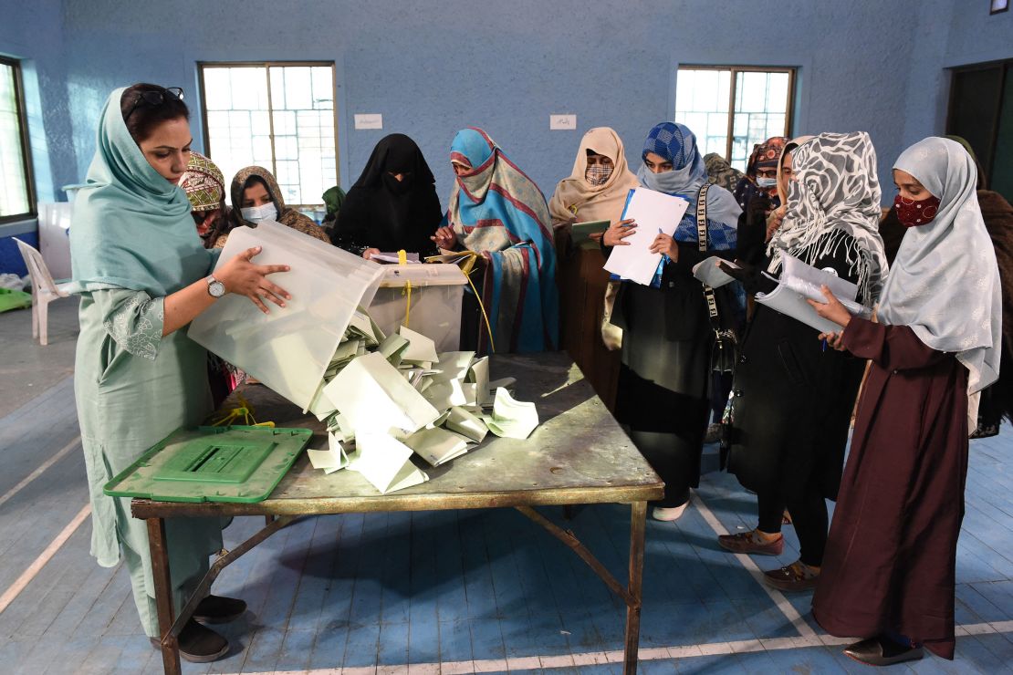 Polling staff open ballot boxes in the presence of polling agents from various political parties as they start counting votes in Quetta, Pakistan on February 8, 2024.