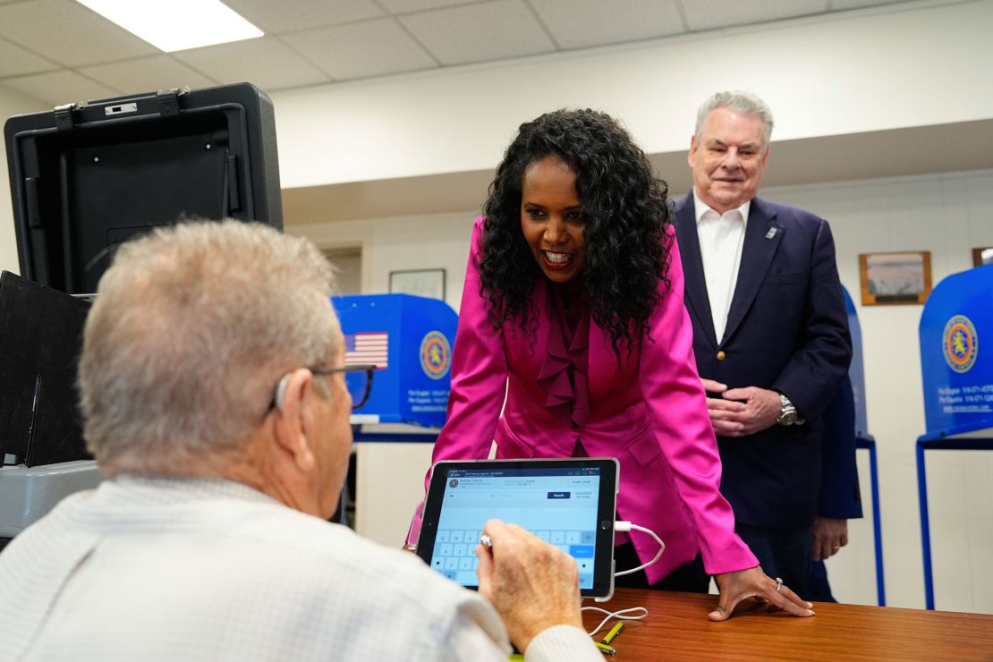 Nassau County Legislator Mazi Pilip, seen here with former New York Rep. Peter King, right, arrives to cast her ballot during early voting in Massapequa, New York, on February 9, 2024.
