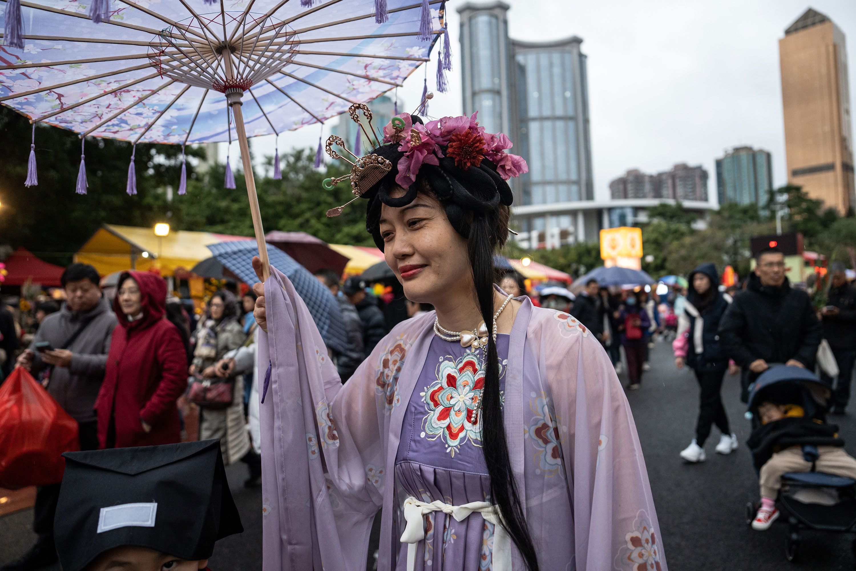 A woman wearing Hanfu strolls around the Spring Festival Flower Market in Guangzhou, China, on February 9, 2024.