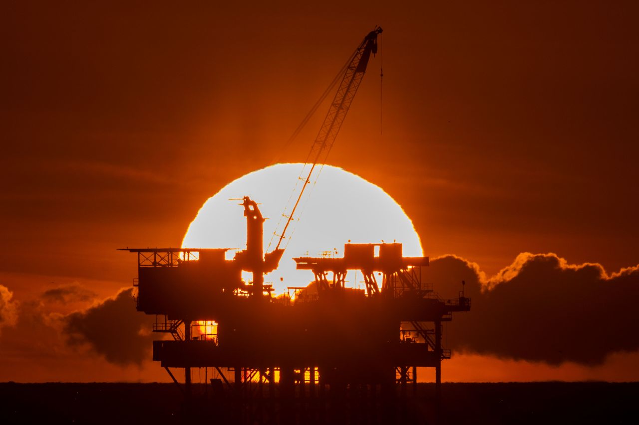  An offshore oil platform is seen at sunset on February 9, 2024, near Huntington Beach, California.