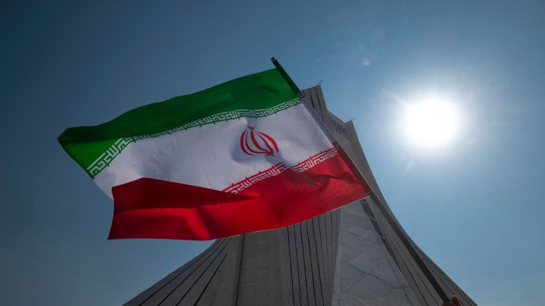 An Iranian waves an Iranian flag in front of the Azadi (Freedom) monument in western Tehran, on February 11.