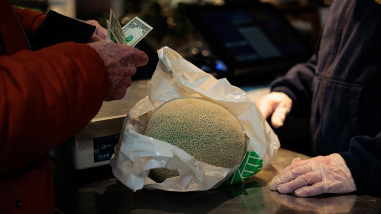 A shopper pays for groceries at the Reading Terminal Market in Philadelphia, Pennsylvania, US, on Monday, Feb. 12, 2024.