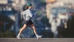 Young woman powerwalking in urban area, profile