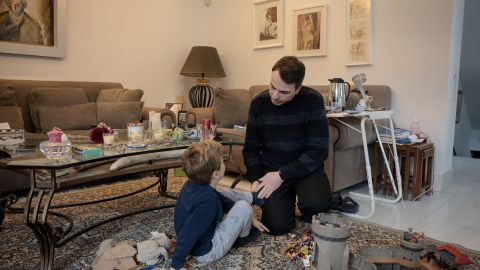 Greek citizen living in London Konstantinos Androulakis speaks with his son in Athens on February 13, 2024, where he came with his partner Michael and their eleven and six years old sons to attend what they say is an "historic day" when the law legalising same-sex marriage and adoption will be approved by the Greek Parliament later this week. Greece had been condemned for anti-gay discrimination by the European Court of Human Rights in 2013, after gay couples were excluded from a prior civil unions law in 2008. Same-sex couples will still not be able to use assisted reproduction or a surrogate mother, procedures reserved for single women or heterosexual couples who have trouble conceiving. Nor will adoption of the child by the second parent be automatic, even if the couple is married, as it will take place after birth. (Photo by Angelos TZORTZINIS / AFP) (Photo by ANGELOS TZORTZINIS/AFP via Getty Images)