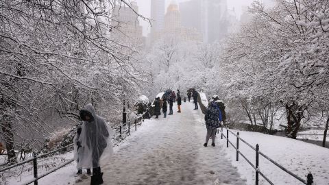 People walk through the falling snow in Central Park on February 13, 2024 in New York City. Heavy snowfall is expected over parts of the Northeast US starting late February 12, with some areas getting up to two inches (5cms) of snow an hour, the National Weather Service forecasters said. (Photo by Yuki IWAMURA / AFP) (Photo by YUKI IWAMURA/AFP via Getty Images)