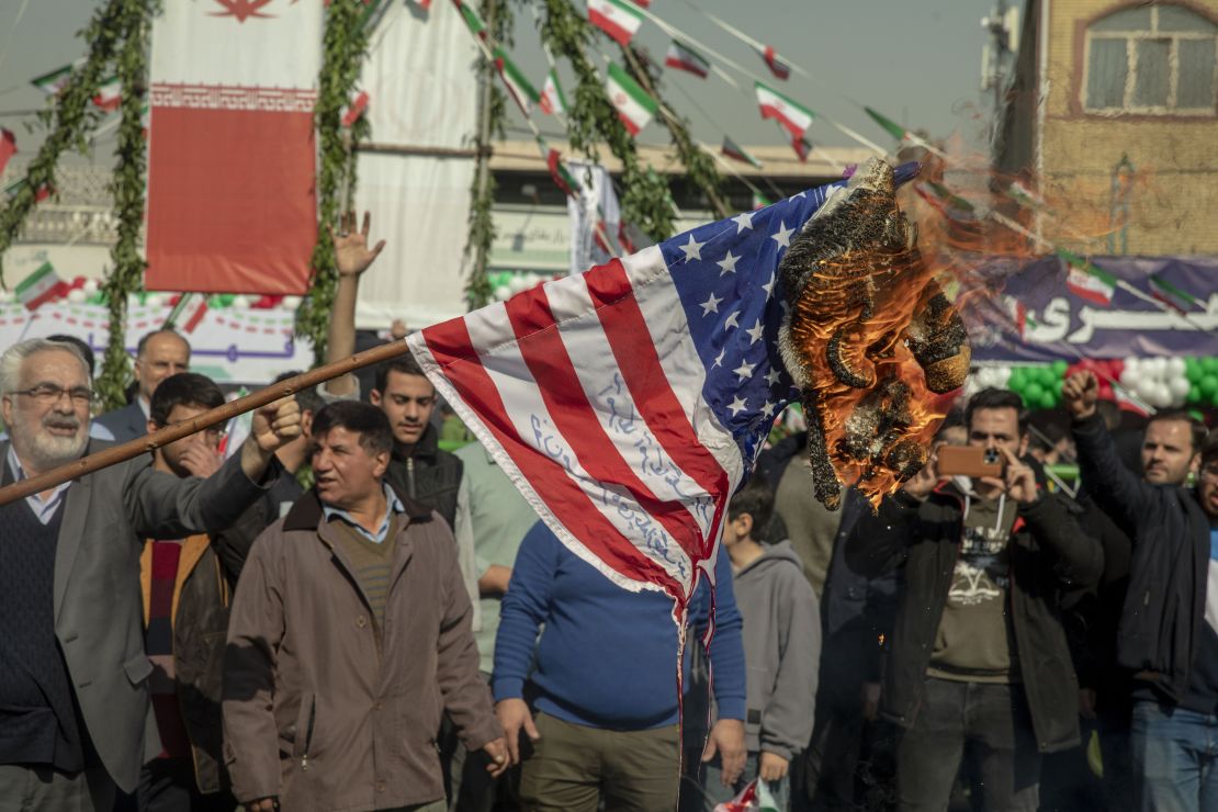 An American flag is set on fire during the annual rally commemorating Iran's 1979 Islamic Revolution in Tehran on Sunday, Feb. 11, 2024.