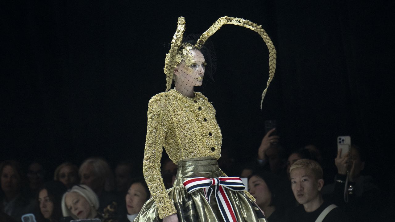 Concluding a show near-completely filled with black and white ensembles, Thom Browne's closing look was glistening gold from head to toe.
