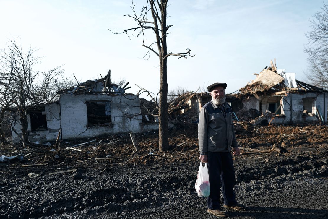 A resident of Avdiivka, Ukraine, near destroyed buildings on February 14.