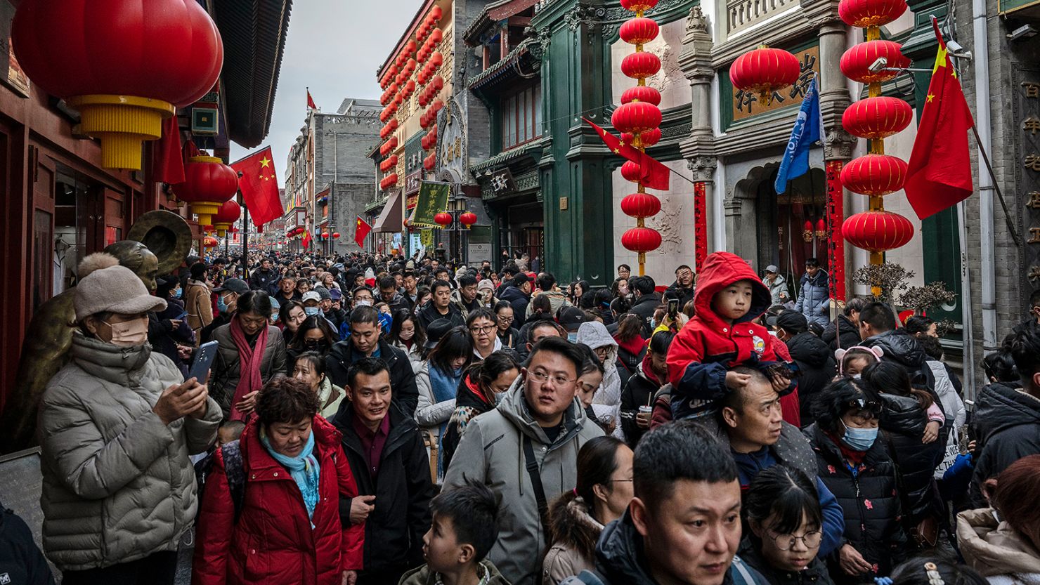 Beijingers flock to a crowded street to celebrate the Lunar New Year on February 11, 2024.