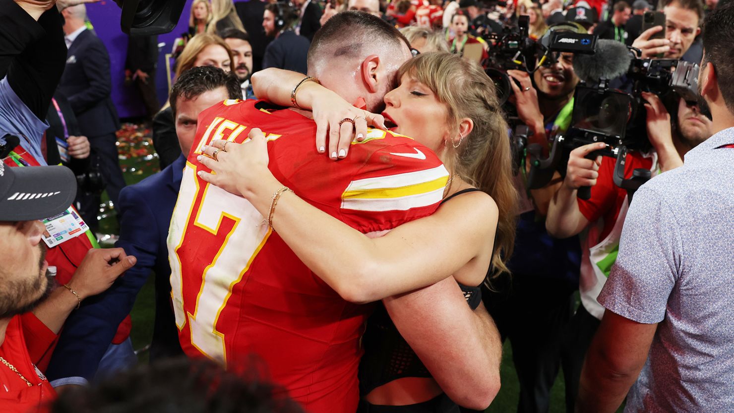 Travis Kelce of Kansas City Chiefs and Taylor Swift embrace after defeating the San Francisco 49ers in overtime during Super Bowl LVIII.