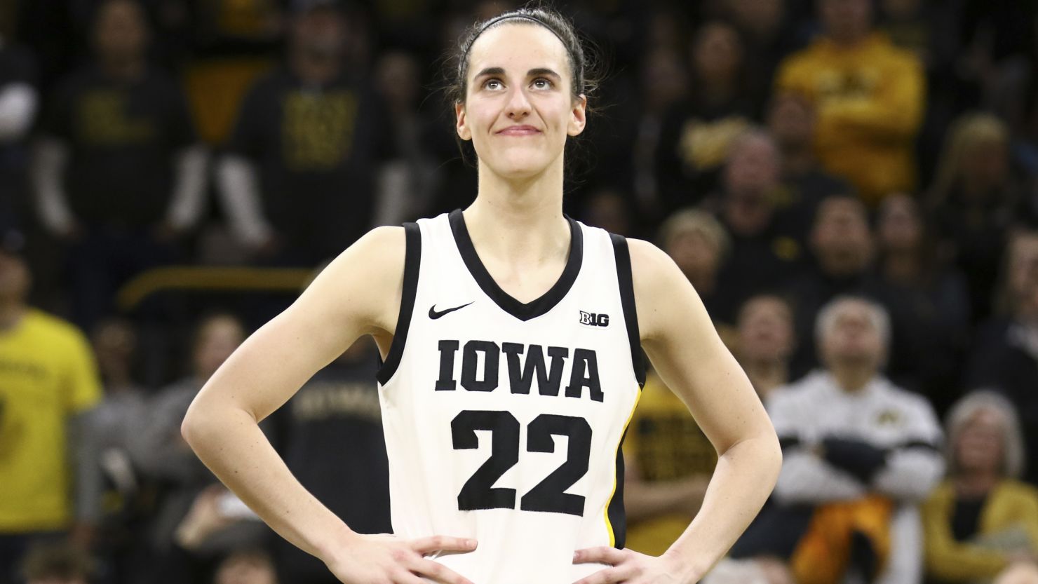 Caitlin Clark listens to cheers after she set the NCAA women's all-time scoring record during a game against the Michigan Wolverines at Carver-Hawkeye Arena on February 15, 2024 in Iowa City, Iowa.