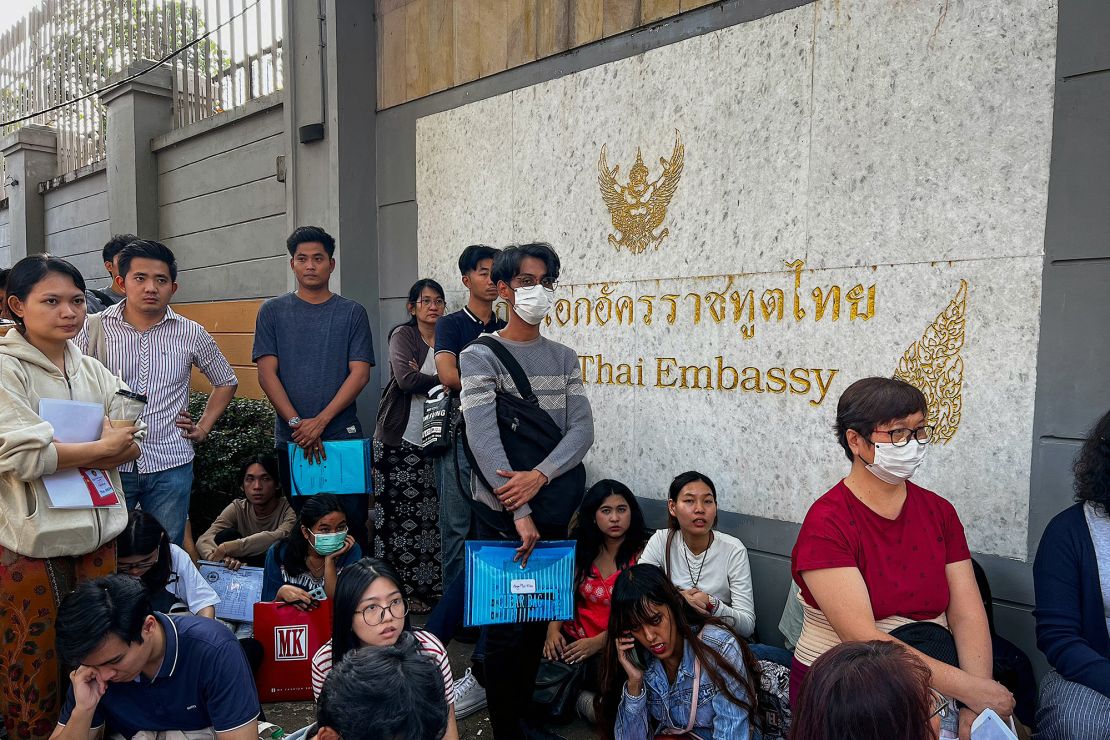 People stand in line for visas at the Thai Embassy in Yangon on February 16, 2024, after Myanmar's military government said it would impose military service.