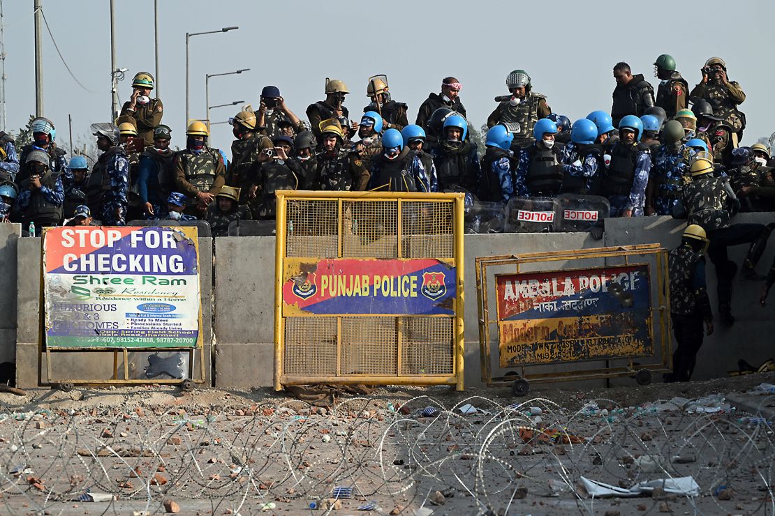 Police and Rapid Action Force (RAF) personnel block a highway to prevent farmers from marching towards New Delhi on February 16, 2024.