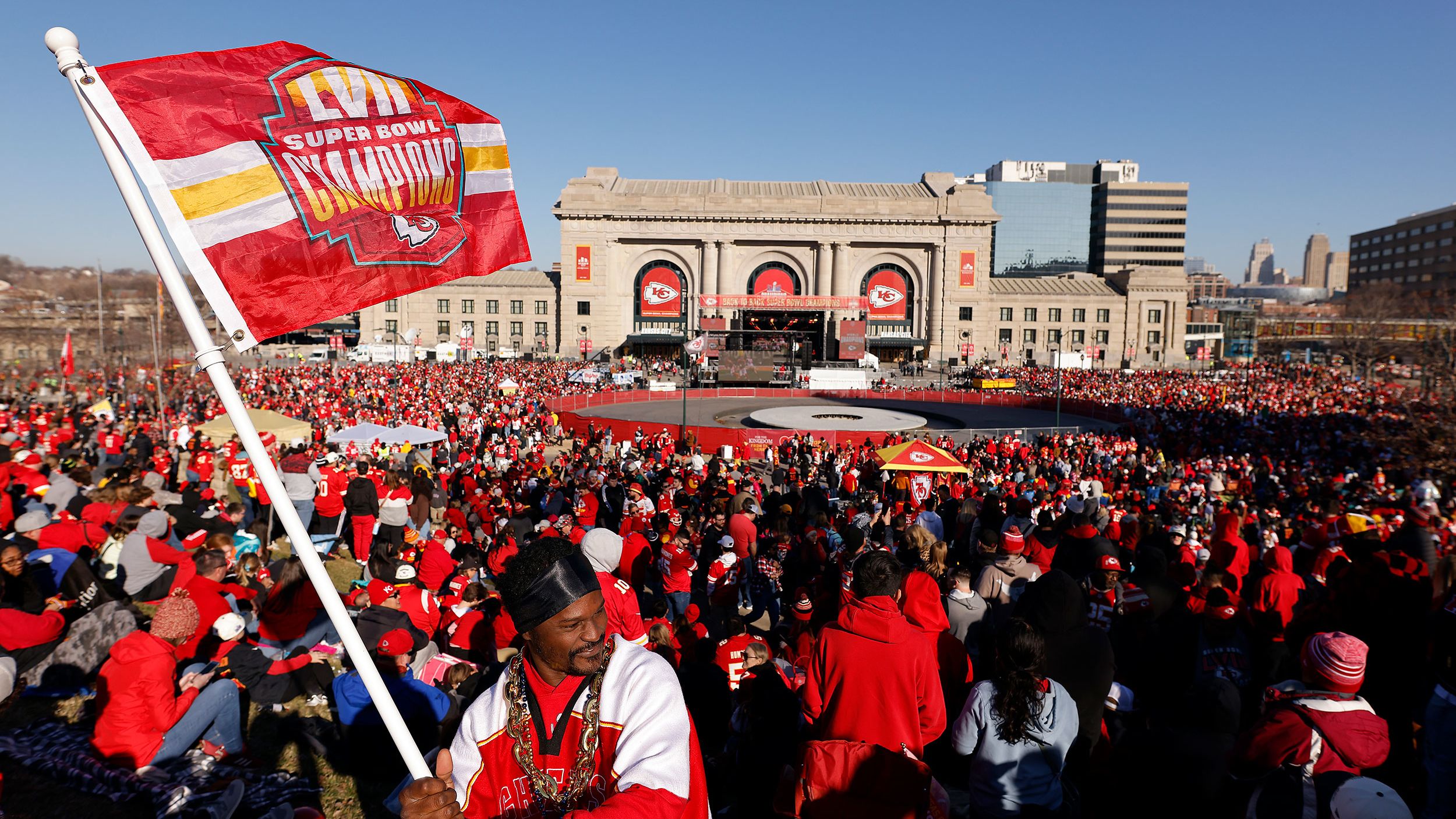 Kevin Moore of Kansas City waves a flag in front of Union Station before the Kansas City Chiefs Super Bowl LVIII victory parade on Wednesday in Kansas City.
