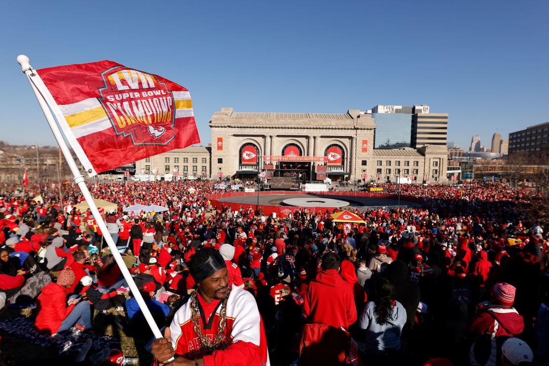 Kevin Moore of Kansas City waves a flag in front of Union Station before the Kansas City Chiefs Super Bowl LVIII victory parade on Wednesday in Kansas City.