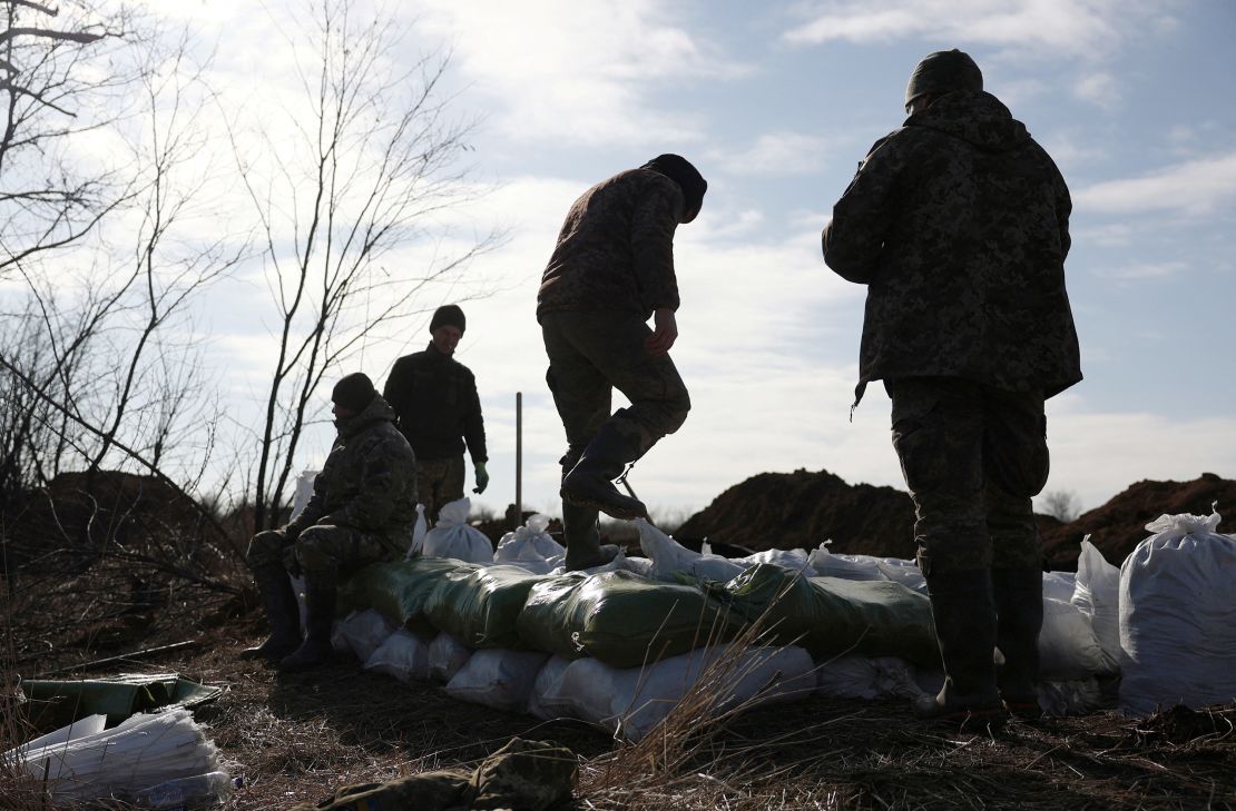 Ukrainian servicemen build a temporary fortification near Avdiivka.