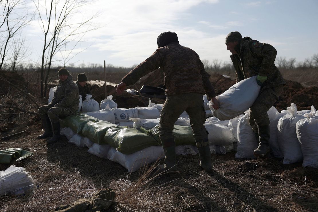 Ukrainian servicemen pile up earthbags to build a fortification not far from the town of Avdiivka in the Donetsk region of Ukraine on February 17.