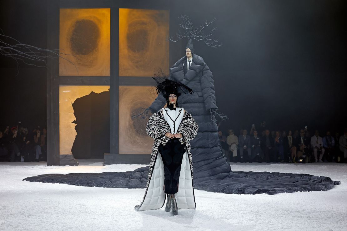 Model Anna Cleveland walks during Thom Browne's theatrical runway show, which took inspiration from Edgar Allan Poe's "The Raven." Cleveland embodied the titular bird.