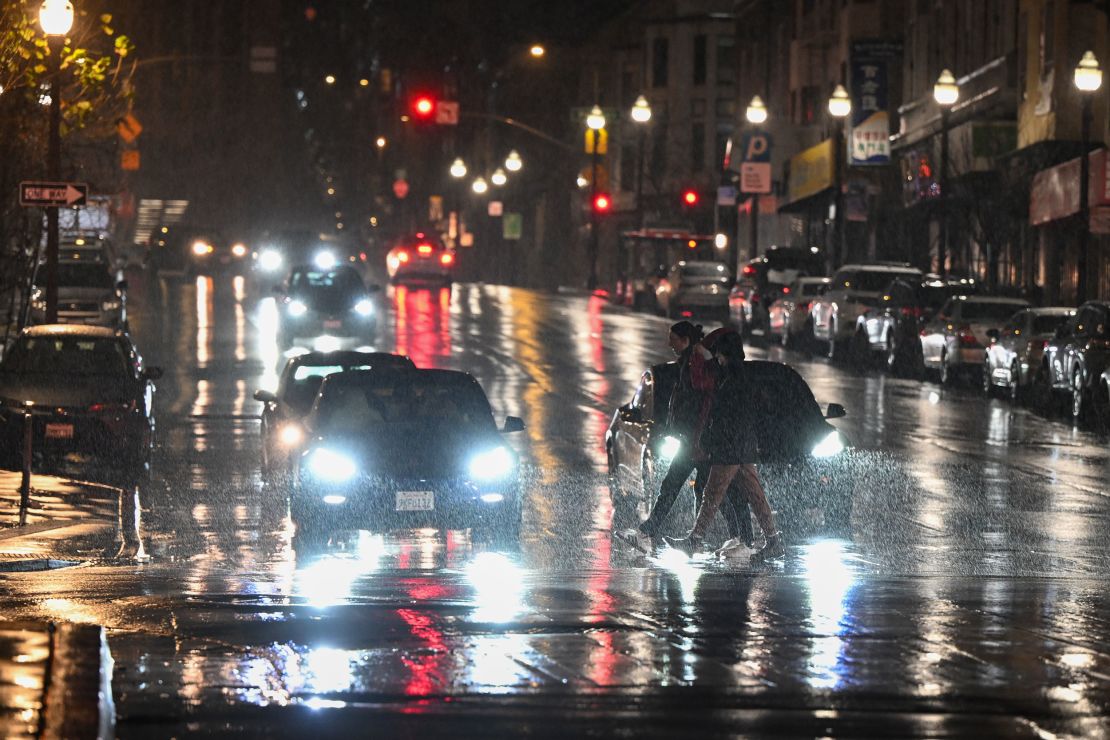 People cross the street in the rain in San Francisco on February 18.