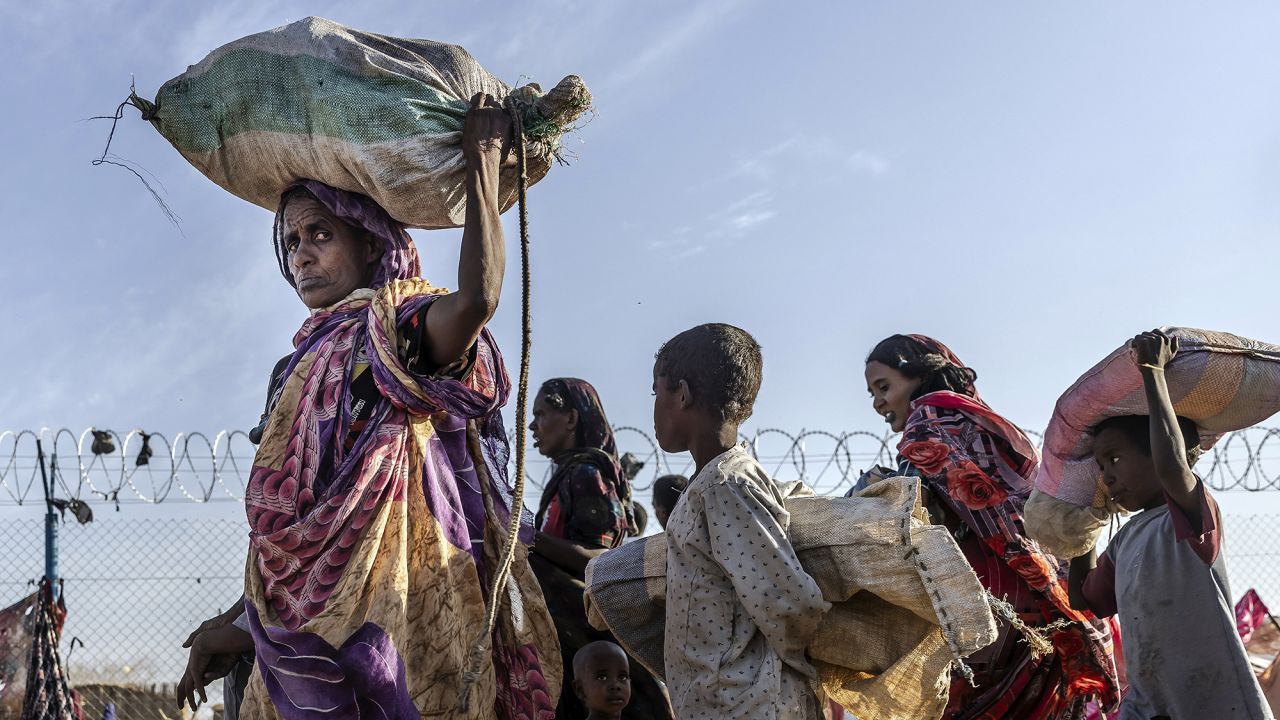 Sudanese families who have fled from the war in Sudan carry their belongings while arriving at a Transit Centre for refugees in Renk, on February 14, 2024.More than 550,000 people have now fled from the war in Sudan to South Sudan since the conflict exploded in April 2023, according to the United Nations. South Sudan, that has itself recently come out of decades of war, was facing a dire humanitarian situation before the war in Sudan erupted and it is feared to not have the resources to host displaced people. The war-torn country of Sudan is currently ravaged by internal fighting between the Sudanese Army and the paramilitary Rapid Support Forces (RSF). (Photo by LUIS TATO / AFP) (Photo by LUIS TATO/AFP via Getty Images)