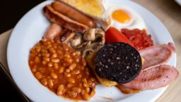 A full English breakfast on a plate in a 'greasy spoon' cafe on 3rd February 2024 in Birmingham, United Kingdom. Also known as a caf, these places provide breakfast and cheap food all day. This meal and these cafes are somewhat of a British institution. Breakfast normally contains the following: Egg, bacon, sausage, mushrooms, black pudding, tomatoes and baked beans, and always comes with toast. (photo by Mike Kemp/In Pictures via Getty Images)