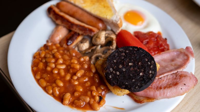 A full English breakfast on a plate in a 'greasy spoon' cafe on 3rd February 2024 in Birmingham, United Kingdom. Also known as a caf, these places provide breakfast and cheap food all day. This meal and these cafes are somewhat of a British institution. Breakfast normally contains the following: Egg, bacon, sausage, mushrooms, black pudding, tomatoes and baked beans, and always comes with toast. (photo by Mike Kemp/In Pictures via Getty Images)