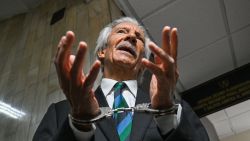 Guatemalan journalist Jose Ruben Zamora, founder of the now defunct newspaper El Periódico, speaks to journalists as he arrives handcuffed for a hearing at the Justice Palace in Guatemala City on February 21,2024. A Guatemalan judge will determine whether imprisoned journalist Jose Ruben Zamora will stand trial for allegedly impeding a money laundering probe. (Photo by Johan ORDÓÑEZ / AFP) (Photo by JOHAN ORDONEZ/AFP via Getty Images)