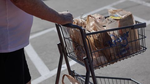 A shopper pushes a shopping cart outside a Kroger grocery store in Dallas, Texas, US, on Wednesday, Feb. 21, 2024.