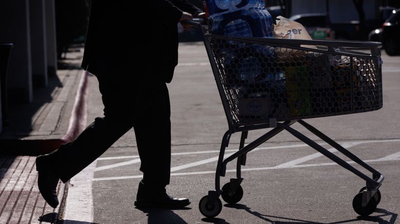 A customer pushes a shopping cart outside a Kroger grocery store in Dallas, Texas, US, on Wednesday, Feb. 21, 2024.