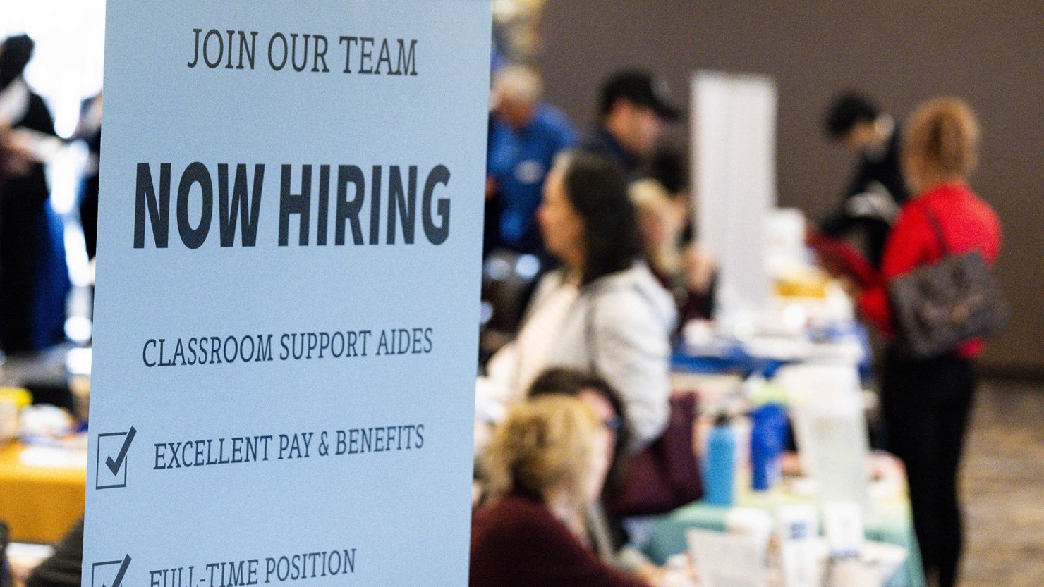 Employers take resumes and talk to prospective new hires at a career fair in Lake Forest, California, in February.