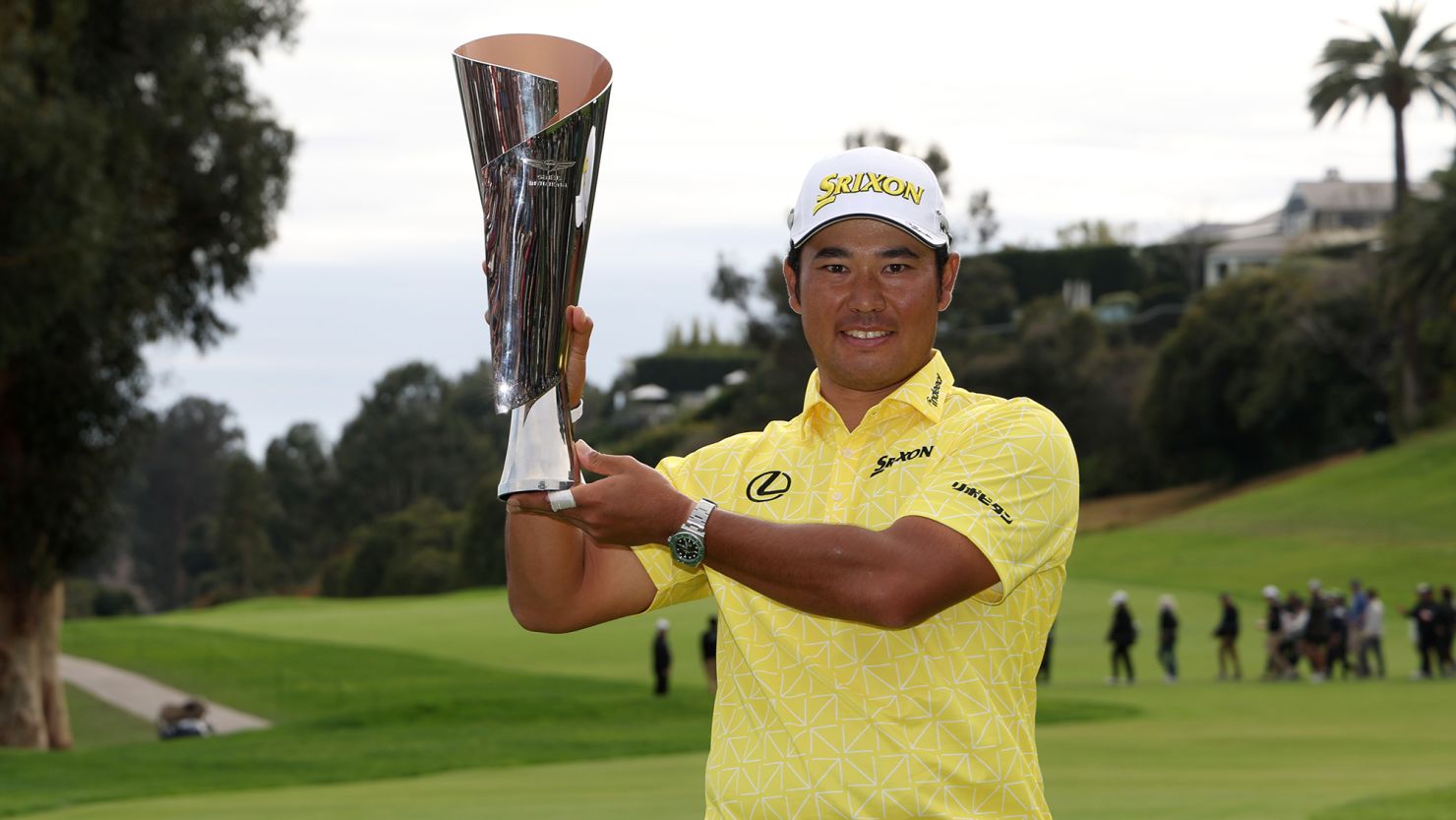 Hideki Matsuyama poses with the 2024 Genesis Invitational trophy after victory at Riviera Country Club in Los Angeles, California.