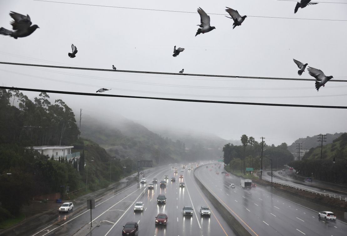 Vehicles drive through the rain on the 101 freeway on Monday in Los Angeles.