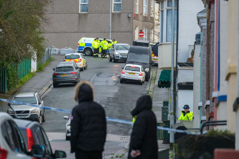 Members of HM Coastguard Search and Rescue gather after homes were evacuated when a suspected WWII explosive device was discovered.