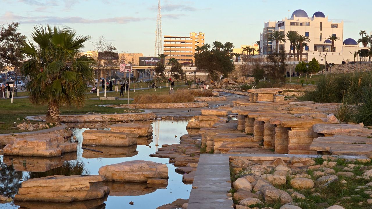 People walk near a park along the seaside corniche in Libya's capital Tripoli on February 22.