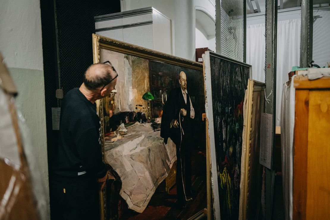 A Kherson Art Museum worker shows one of the remaining works left: a painting of Vladimir Lenin.