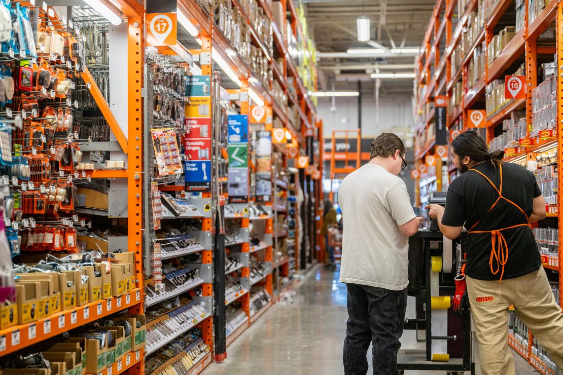 An employee assists a customer at The Home Depot store on February 20, 2024, in Austin, Texas.