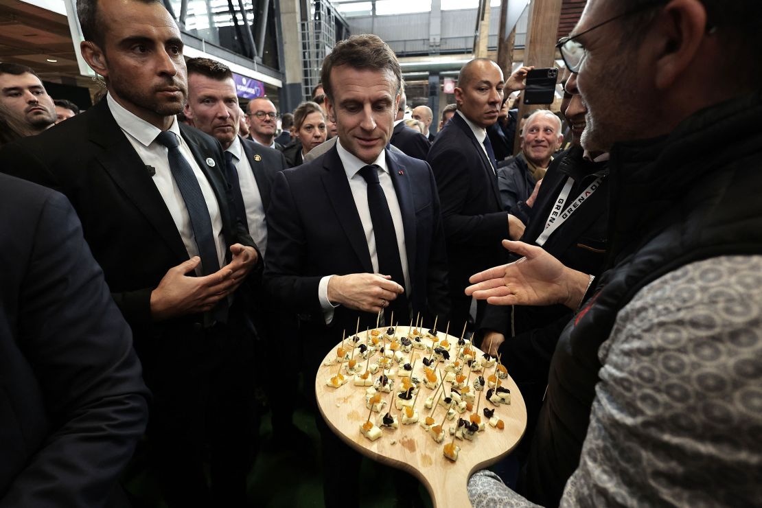 All the president's cheese: France's Emmanuel Macron eyes up some Camembert at a fromage fair in Paris.