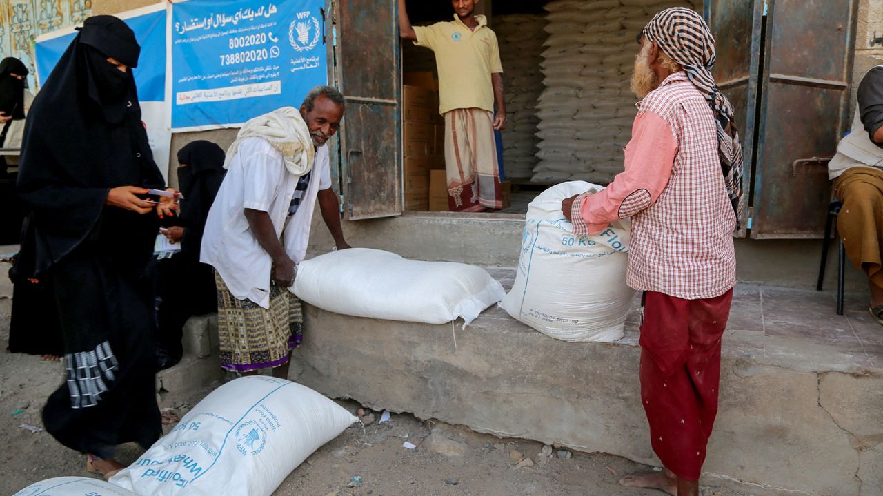 Displaced Yemenis receive humanitarian aid provided by the World Food Program in the Hays region, south of Hodeidah Governorate in western Yemen on February 24, 2024.