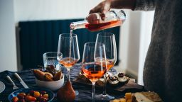 Pouring rose wine at a dinner party with friends.