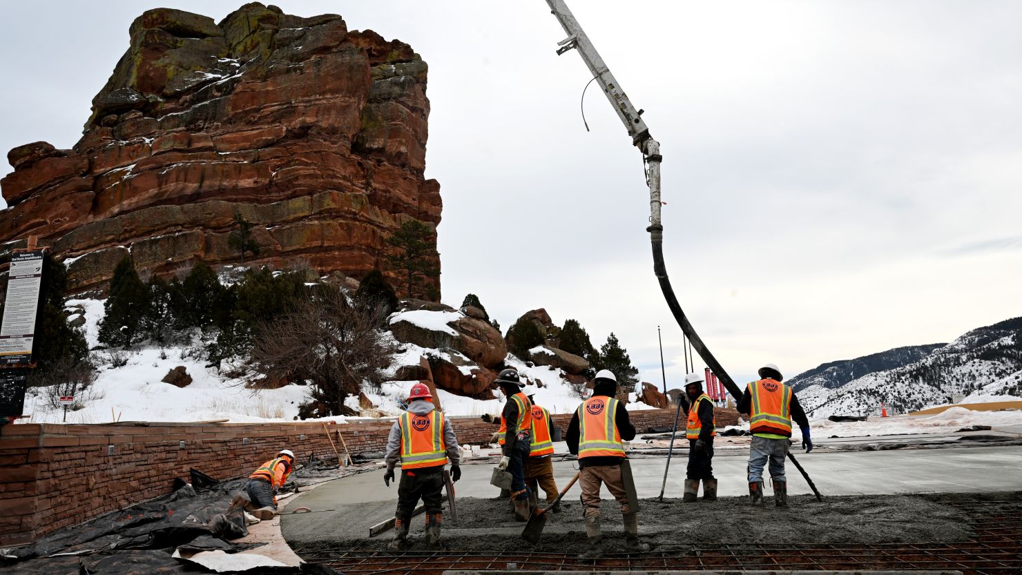 Construction workers pour concrete in the upper parking lot at Red Rocks Park and Amphitheatre on February 6, 2024, in Morrison, Colorado.