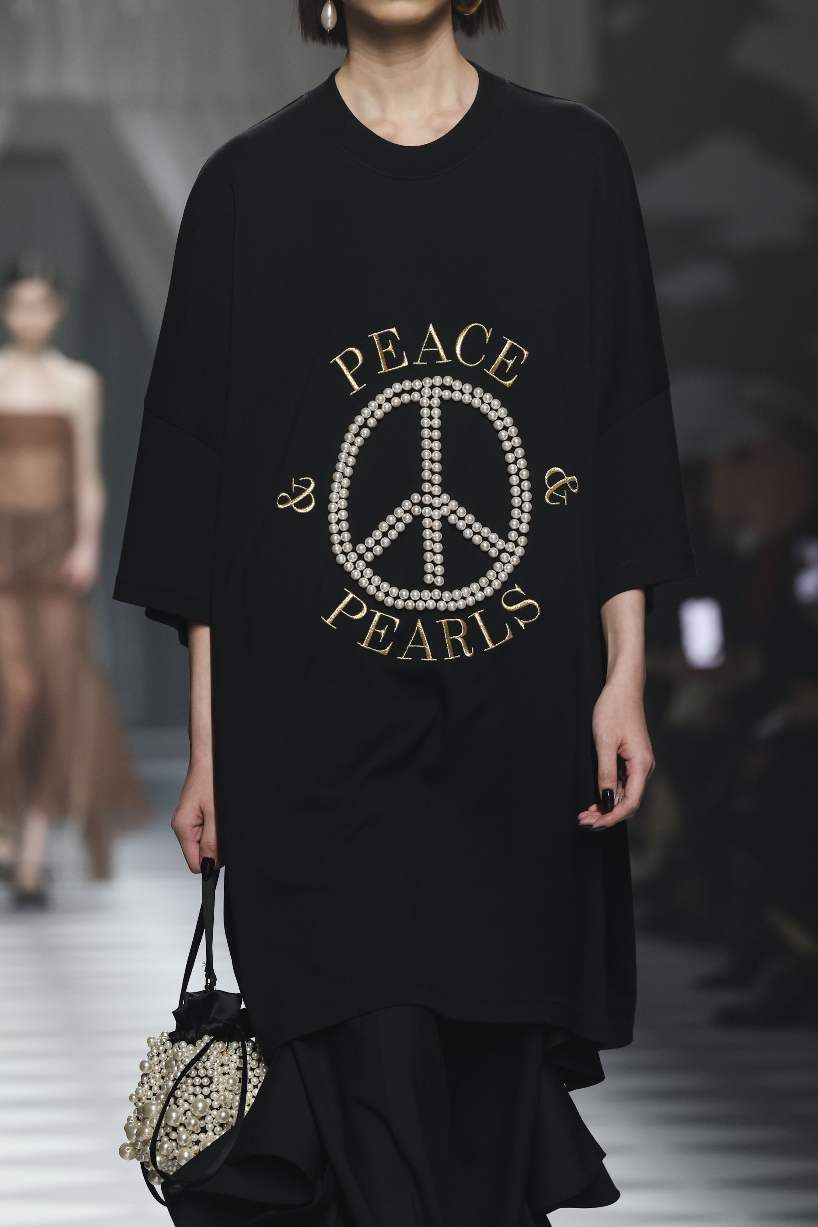 Appiolaza said it was "natural" that Franco Moschino's famous "peace" theme appeared in his first show.
