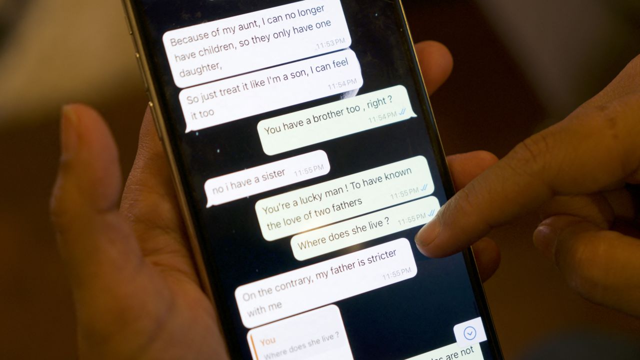 Messages that Shreya Datta, a tech professional who was a victim of an online scam known as "pig butchering," exchanged with a person who would later turn out to be a scammer are displayed on her phone in Philadelphia, Pennsylvania, on February 9, 2024. The "wine trader" wooed her online for months with his flirtatious smile and emoji-sprinkled texts. Then he went for the kill, defrauding the Philadelphia-based tech professional out of $450,000 in a cryptocurrency romance scam. The con, which drained Datta, 37, of her savings and retirement funds while saddling her with debt, involved the use of deepfakes and a script so sophisticated that she felt her "brain was hacked." (Photo by Bastien INZAURRALDE / AFP) (Photo by BASTIEN INZAURRALDE/AFP via Getty Images)