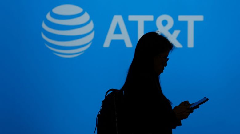 A visitor walks past US multinational telecommunications AT&T logo during the Mobile World Congress (MWC), the telecom industry's biggest annual gathering, in Barcelona on February 26, 2024. The world's biggest mobile phone fair throws open its doors in Barcelona with the sector looking to artificial intelligence to try and reverse declining sales. (Photo by PAU BARRENA / AFP) (Photo by PAU BARRENA/AFP via Getty Images)