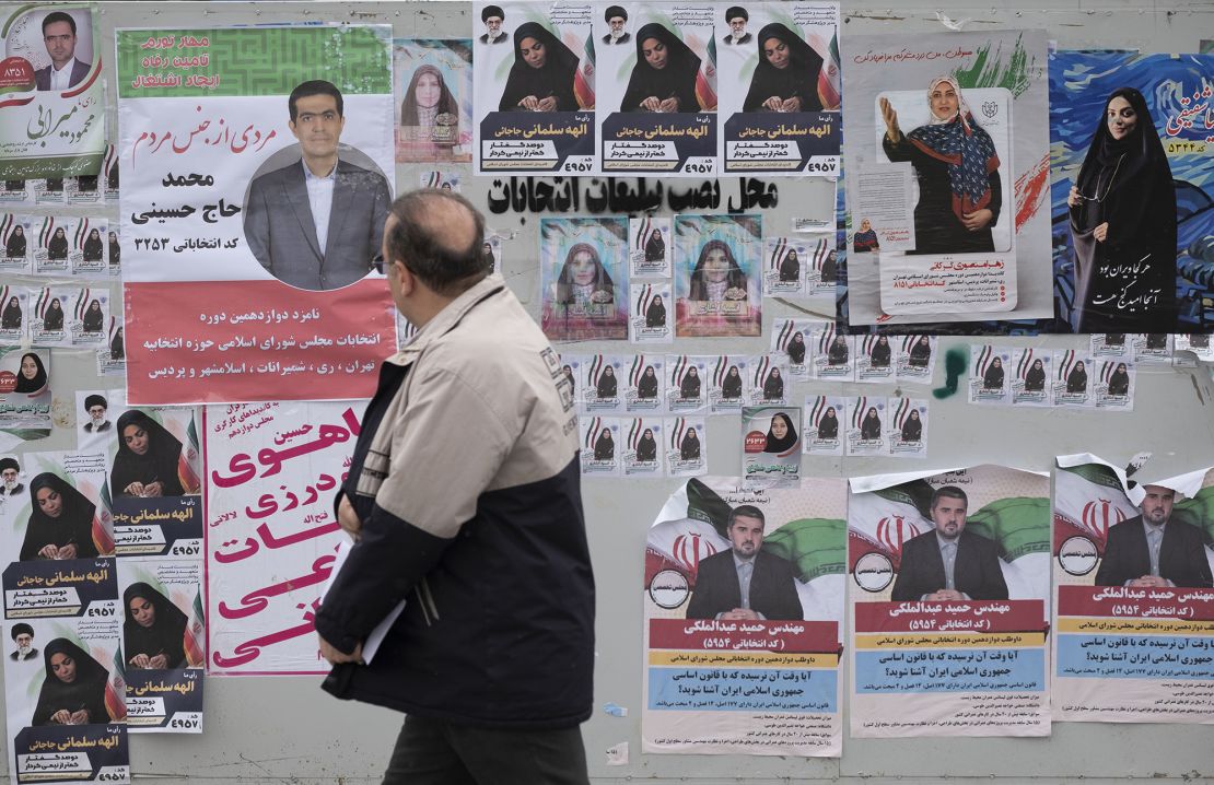 A man looks at electoral posters in downtown Tehran, Iran, on February 26, 2024, four days before the parliamentary elections.