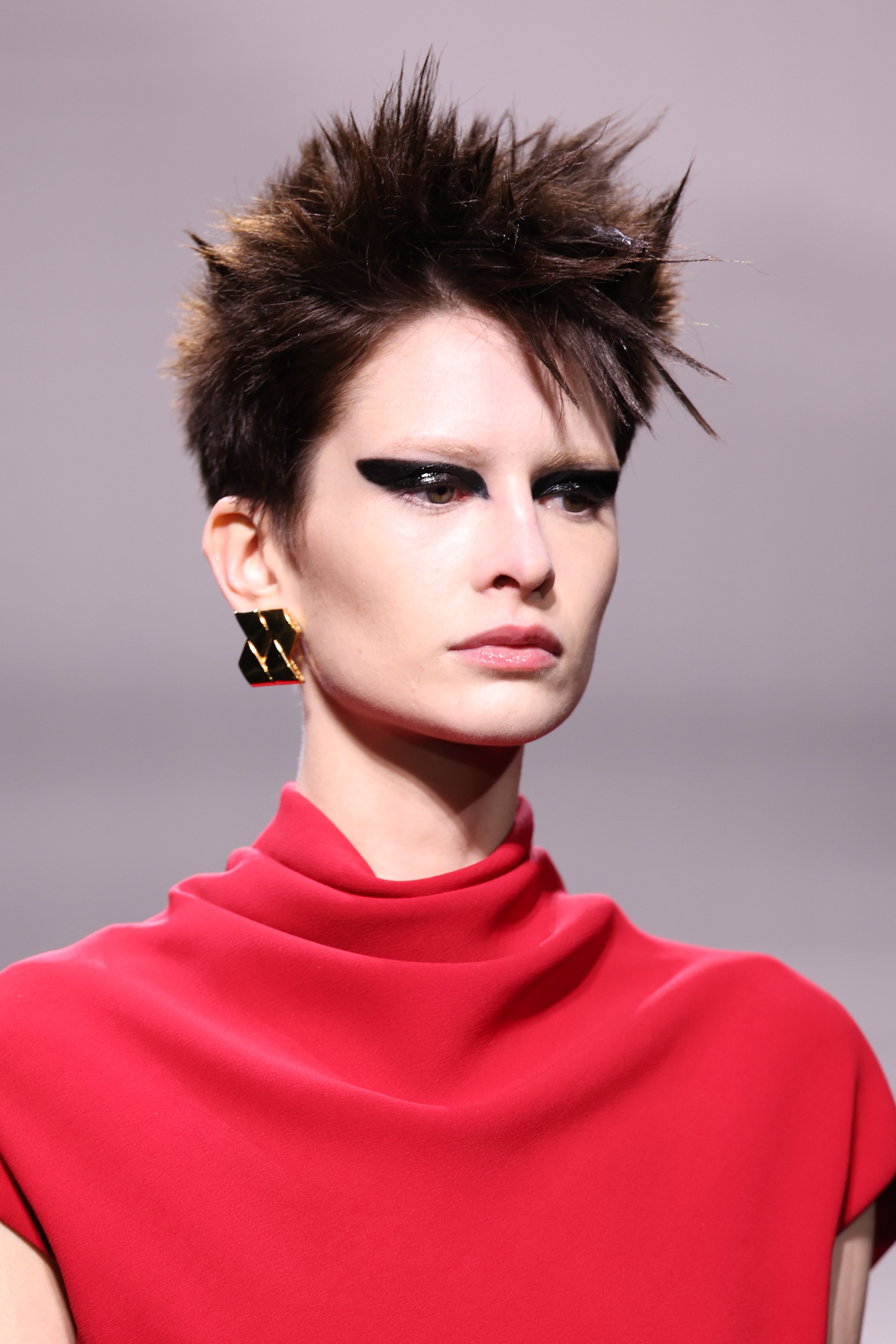A model with '80s inspired hair and make-up at Versace. 