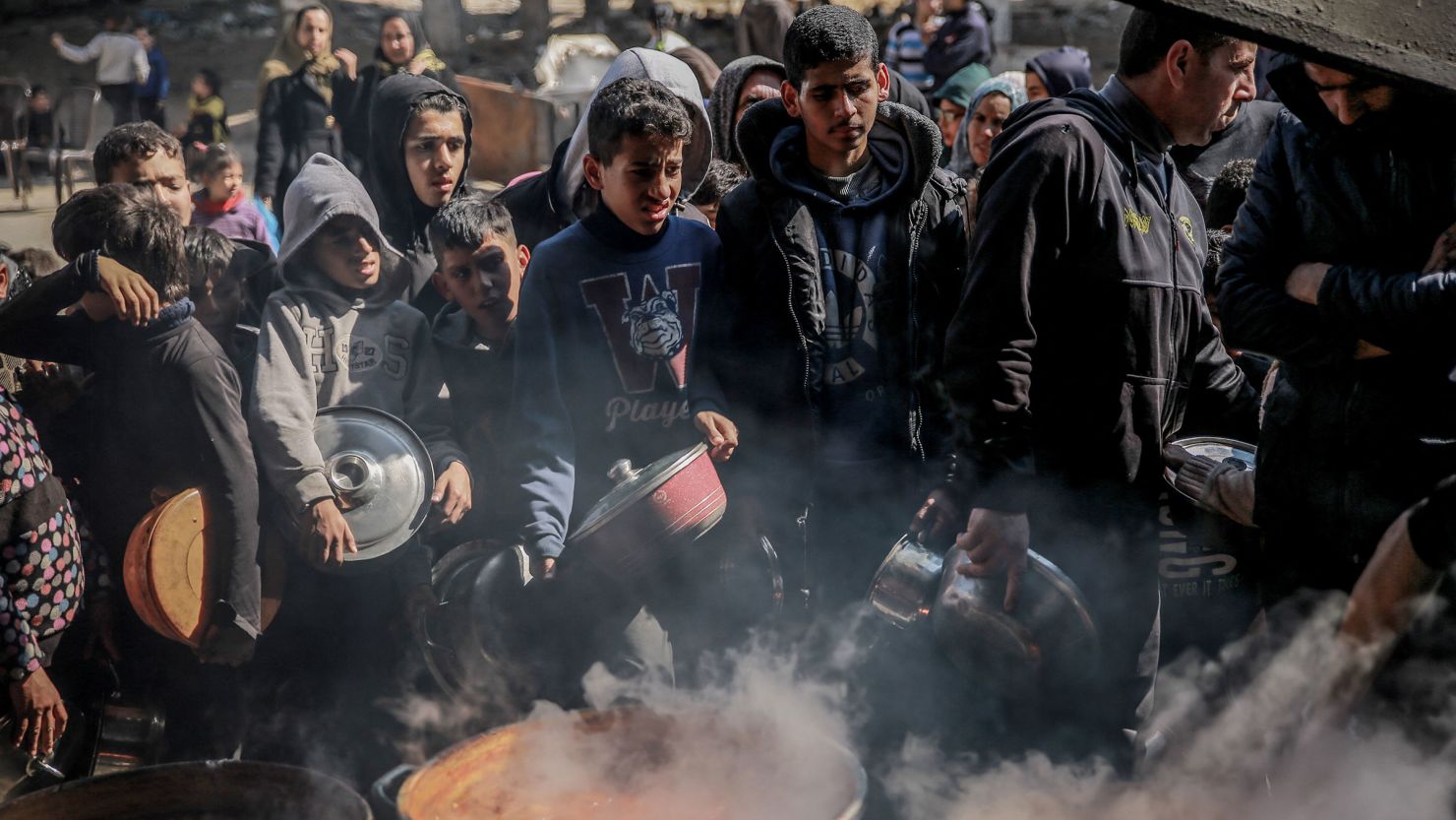 Palestinians gather to collect aid food in Beit Lahia, in the northern Gaza Strip, on February 26.