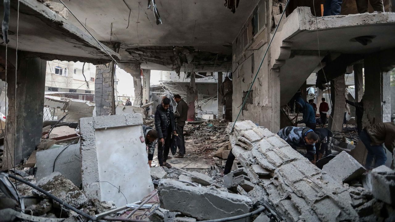 People inspect damage to their homes following Israeli air strikes on February 24, in Rafah, Gaza.
